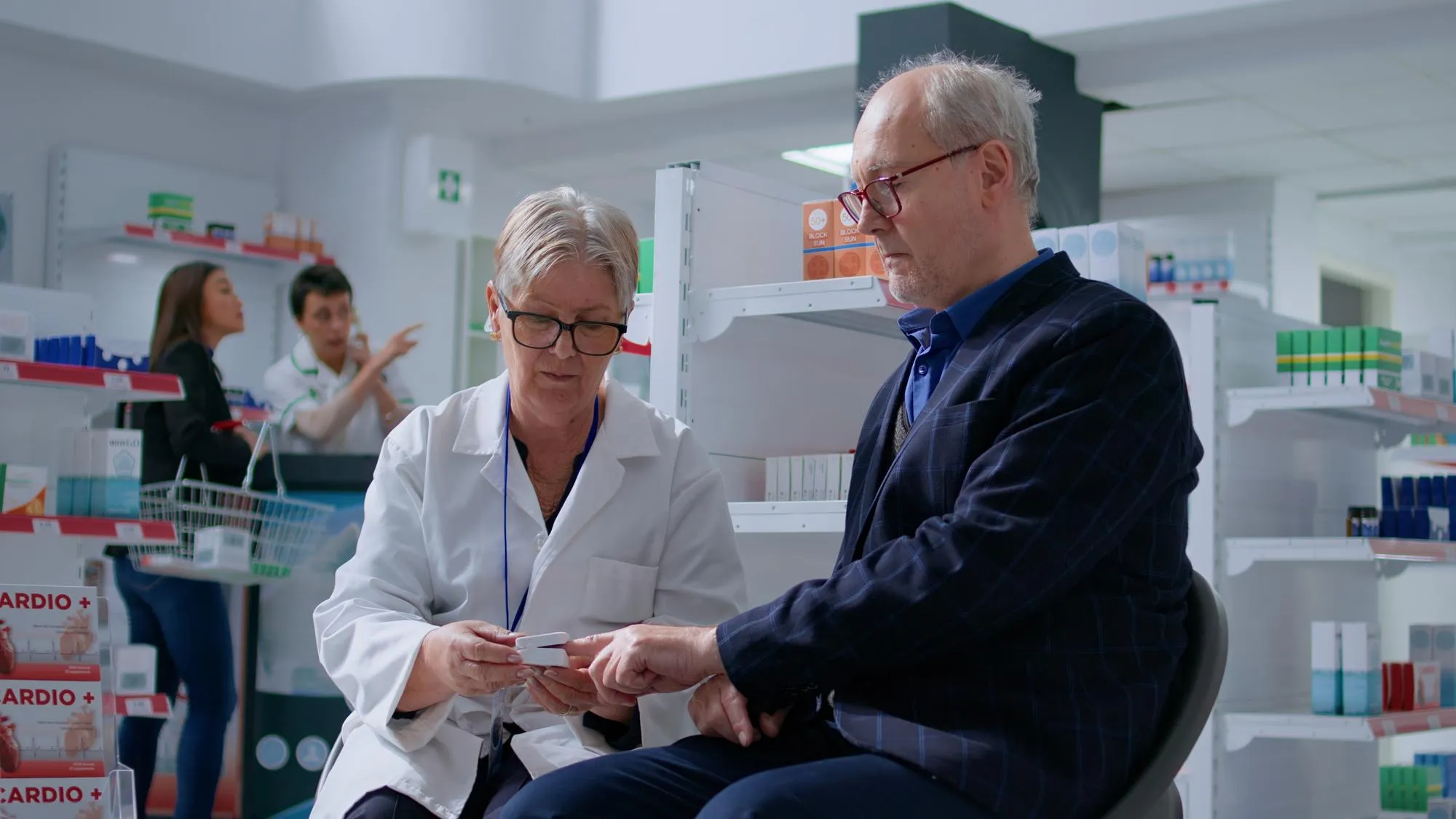 Healthcare professional discussing prior authorization services with a patient at a pharmacy.