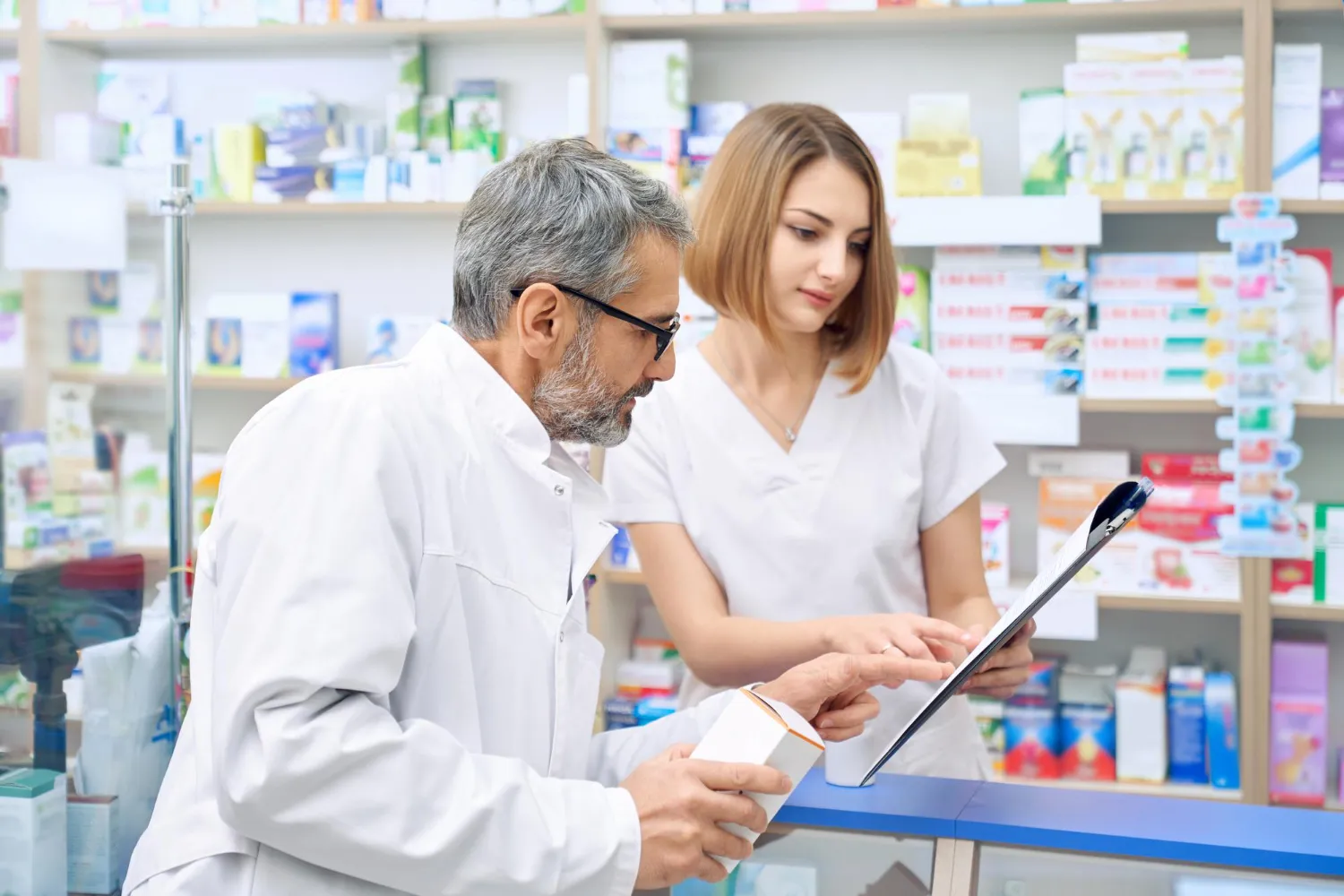 Pharmacist reviewing EPA Assistance for Pharmacies information and ePA services in a pharmacy.