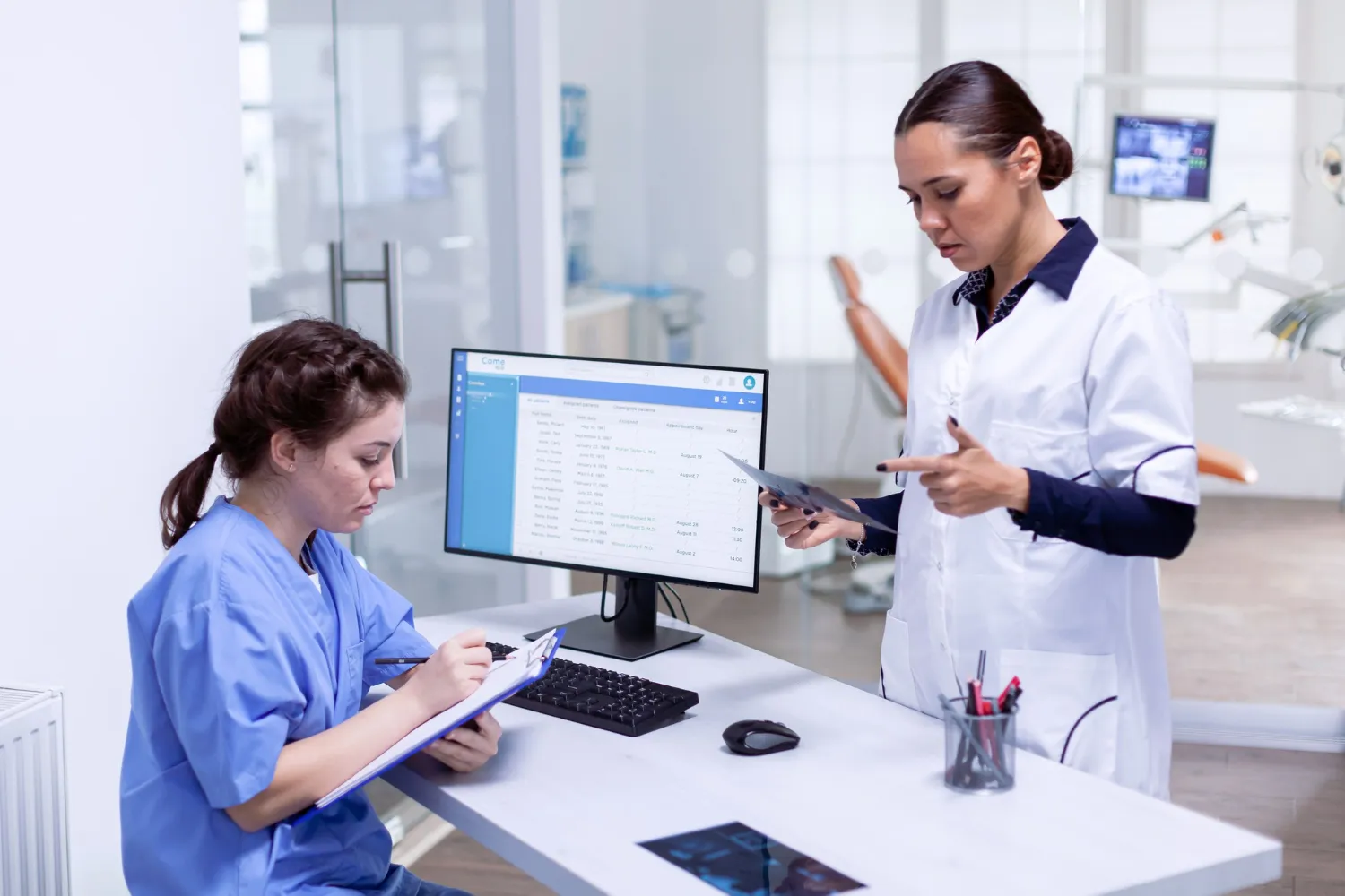 Healthcare professionals using prescription management for pharmacies software to review patient records and streamline pharmacy prescription management workflows.