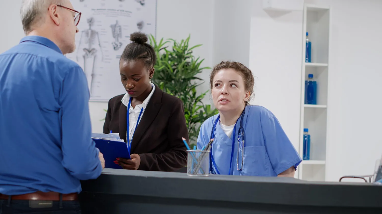 Healthcare staff providing patient assistance with prior authorization and ePA prior authorization services at a medical clinic.