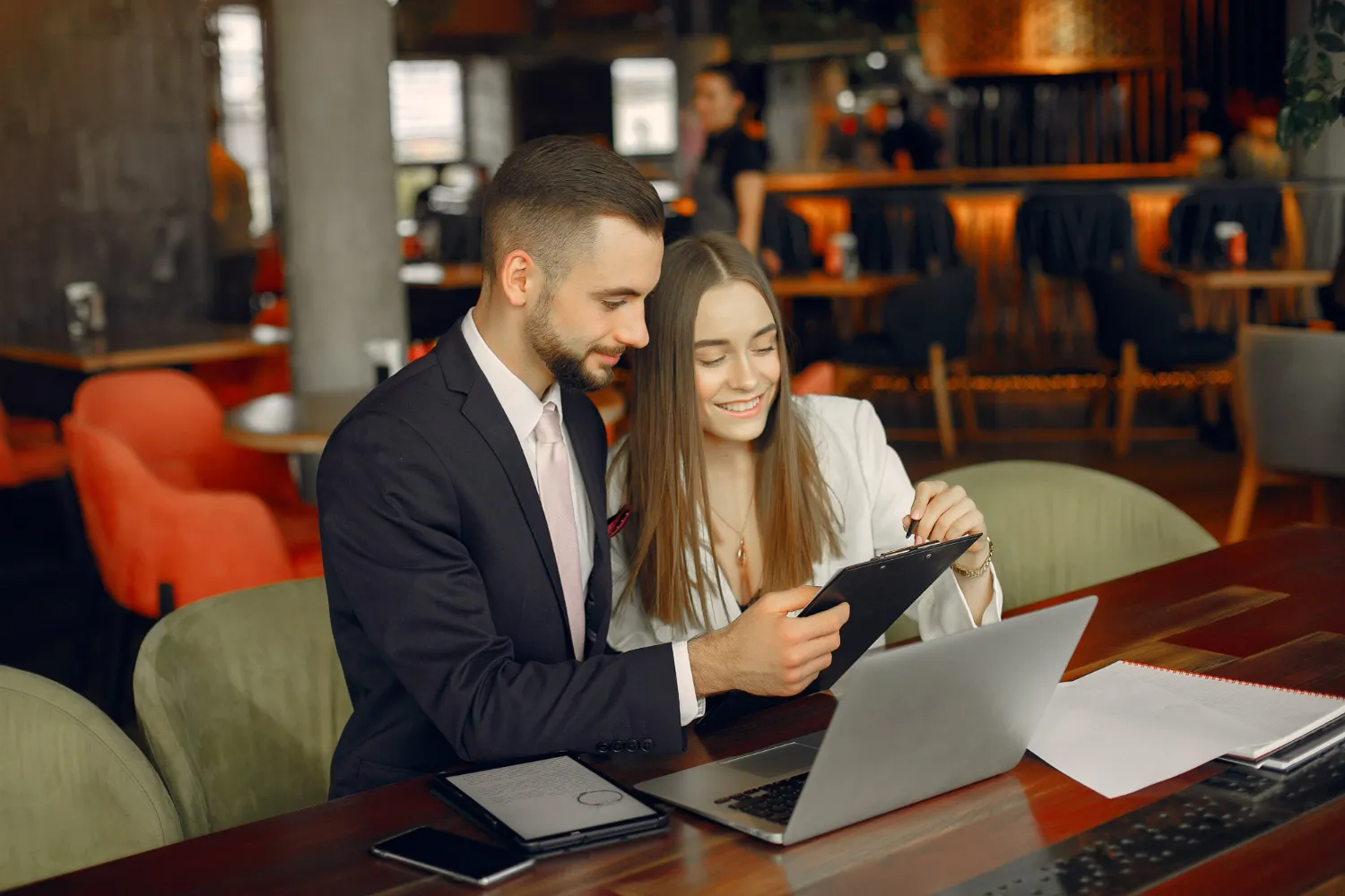 HHealthcare professionals reviewing documents on a tablet and laptop, representing streamlined workflows and efficient prior authorization in healthcare for faster approvals