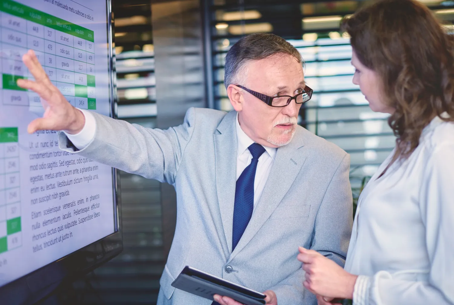 Healthcare professionals reviewing data on a digital screen, showcasing collaborative payor provider enrollment support and integrated healthcare workflow solutions