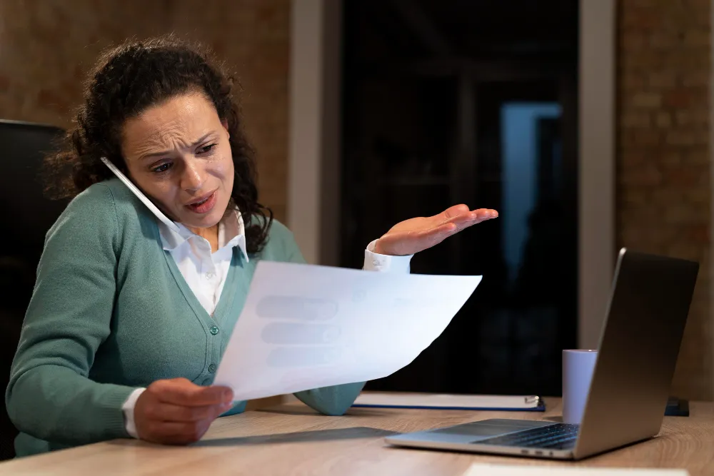 Patient confused over prior authorization denial while reviewing medical documents and insurance paperwork