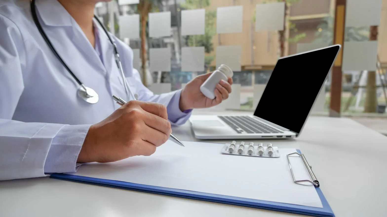 Doctor processing medication approval using prior authorization services to streamline prescription authorization workflow