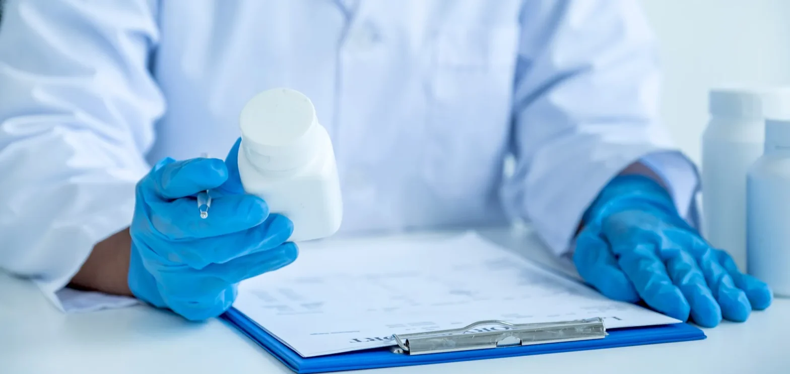 Prescribers medication authorization solutions with pharmacist reviewing prescription and approval documentation
