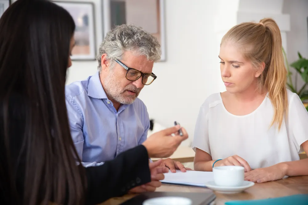 Healthcare professional discussing treatment and documentation with patients, illustrating PA Support Programs for Patients and assistance with navigating insurance approvals