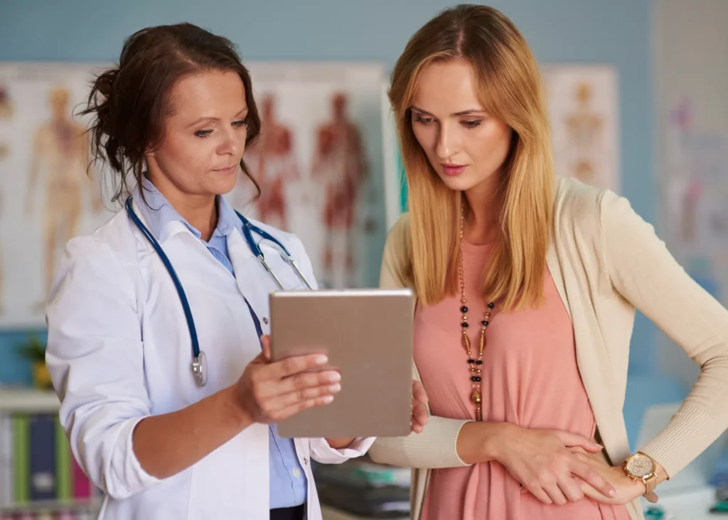 Patient-focused illustration showing healthcare interaction and support, representing improved patient outcomes, care coordination, and seamless access to medications through digital systems