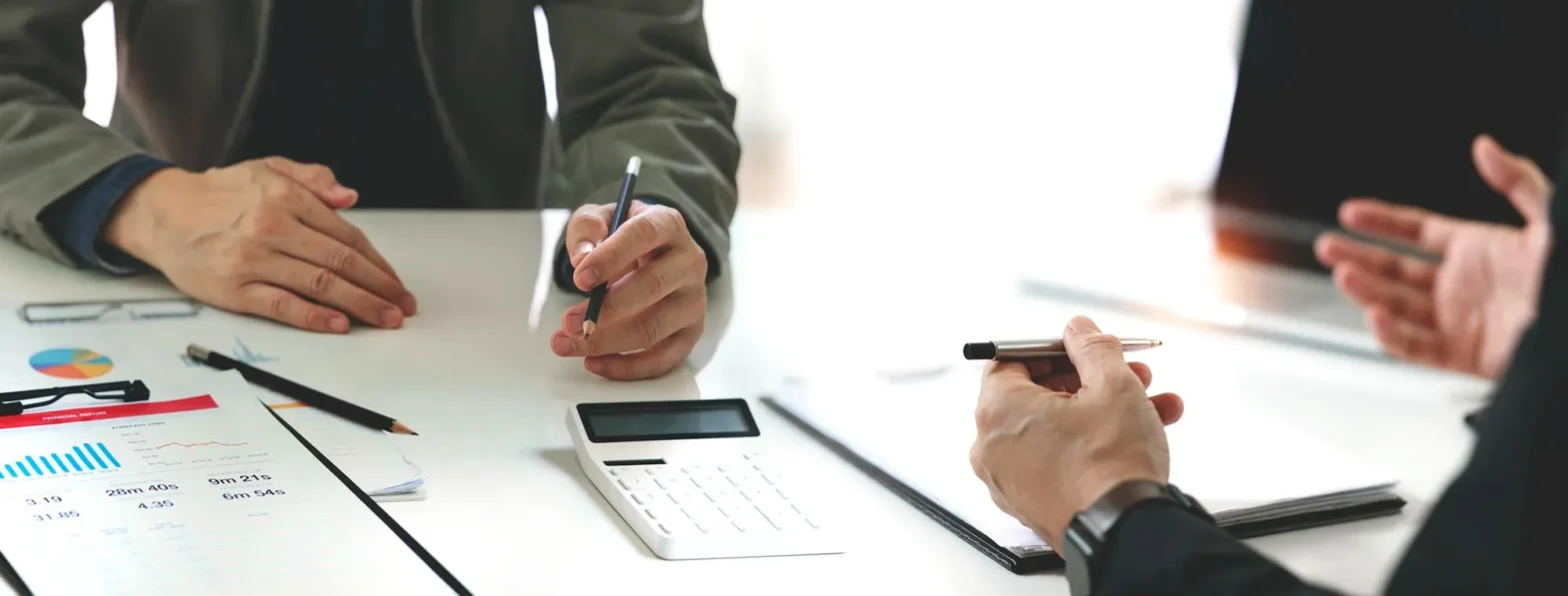 Healthcare professionals discussing prior authorization documents and claim approvals, illustrating how electronic prior authorization vendors and ePA solutions help reduce claim rejections and medication delays.