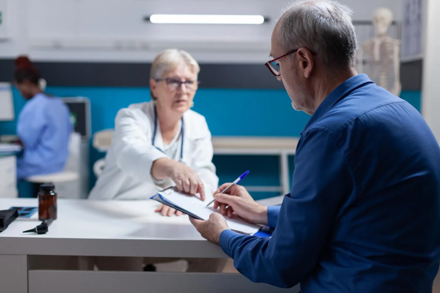 Healthcare provider reviewing a prior authorization request with a patient, streamlining approvals through an ePA platform for prescribers.