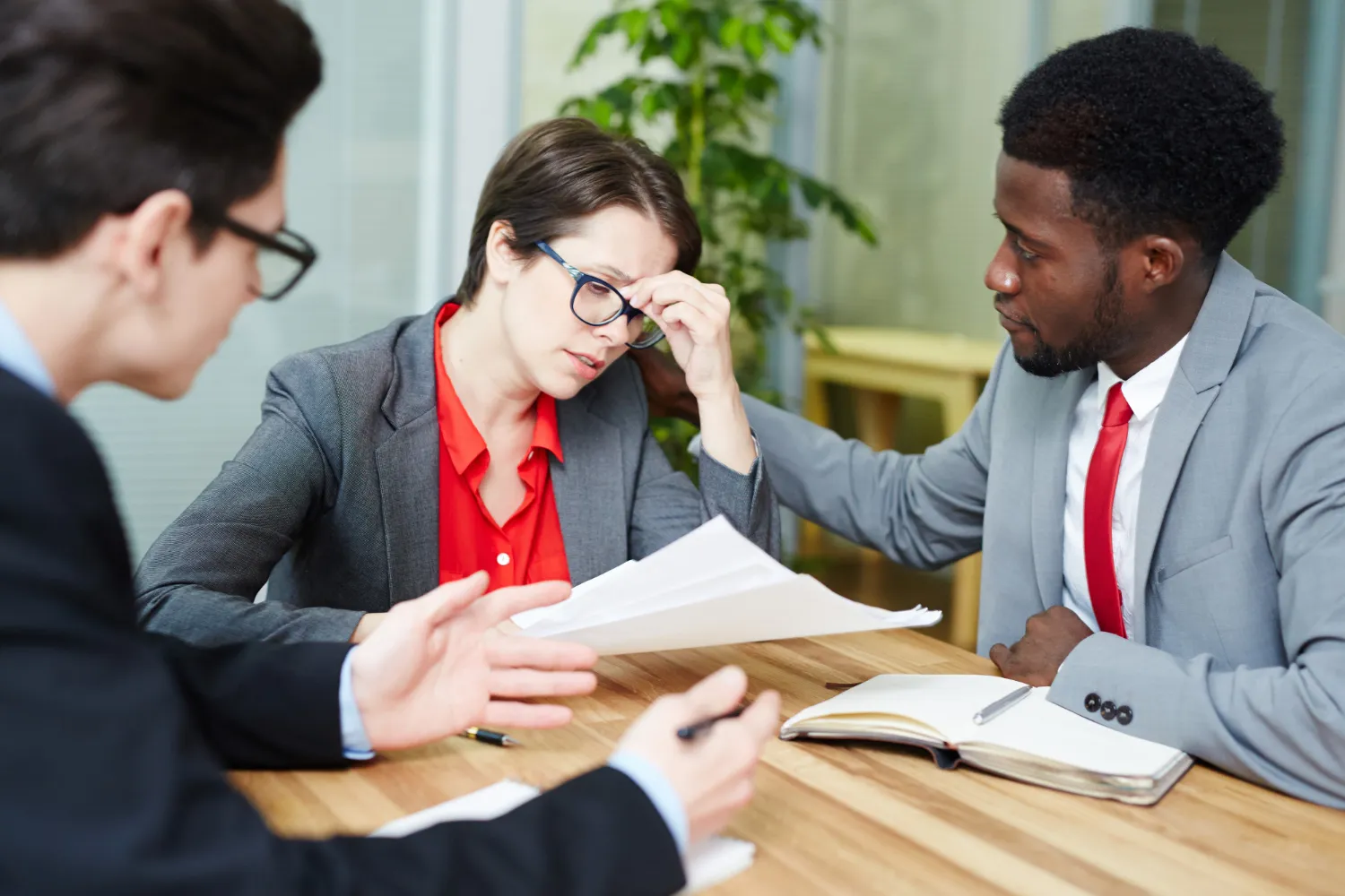 Healthcare professionals reviewing insurance authorization paperwork during a meeting, highlighting how PA Rx solutions and electronic prior authorization services reduce claim denials and accelerate medication access.