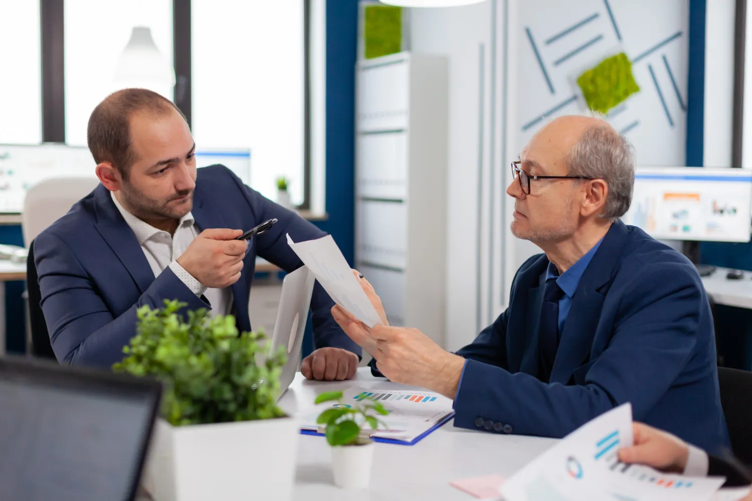 Healthcare professionals reviewing authorization documents during a Prior Authorization for Payors meeting, streamlining claims processing with a Customized Prior Authorization Platform.