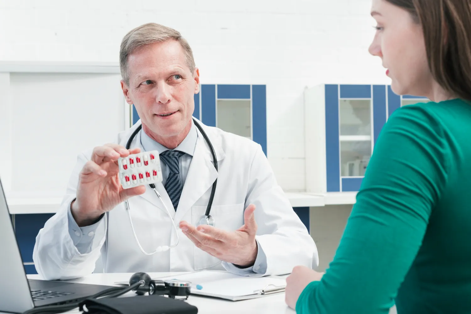 Pharmacist discussing medication and prior authorization services for pharmacies with a patient.
